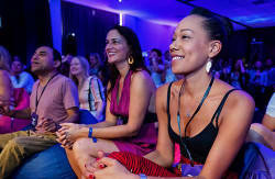 Mindvalley students watches an author speak on stage