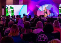 Author on stage at Mindvalley Live