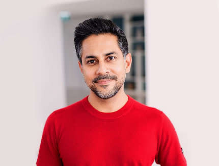 Vishen Lakhiani in a red shirt